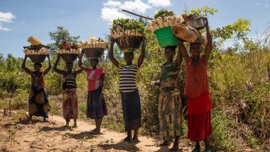 Women return from farmland with baskets of vegetables and firewood in the DRC. Photo: Hugh Kinsella Cunningham/Concern Worldwide