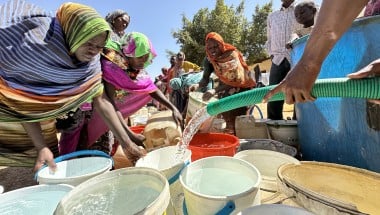 Women collect water delivered by a tanker through UNICEF’s partner, Jebel Marra Charity Organization for Rural Development (JMCO), to the temporary camp for displaced people at Al Rabad School. Water trucking is provided as a temporary measure while damaged boreholes are repaired. Photo: Donaig Le Du/UNICEF