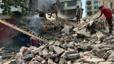 People stand on top of rubbble from the Myanmar earthquake