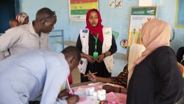 Concern staff in Sudan standing at table and speaking
