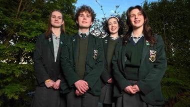 Four secondary school students standing together