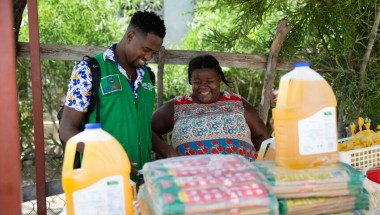 Concern's staff with Justa, a small trader in the Cité Soleil area of Port-au-Prince. Photo: Kieran McConville/Concern Worldwide.