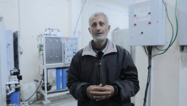A man stands in front of a water filter in a hospital