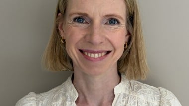 Headshot of a woman smiling with short blonde hair