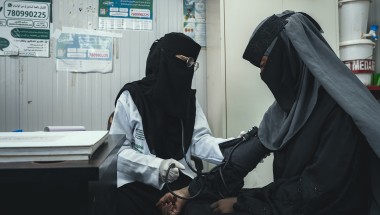Woman providing health check up to a patient