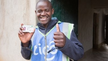 Jean Claude Minani shows off his prized motorcycle driver’s licence. He participated in Concern’s graduation programme in Rwanda and was able to start his own motorcycle taxi business. Photo: Robin Wyatt / Concern Worldwide, 2015