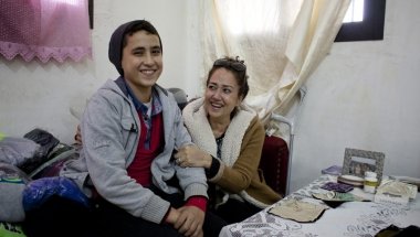 Rabia, a member of the Concern-funded sewing workshop in Tripoli, Lebanon, with her son. Credit: Abbie Traylor-Smith/Panos for Concern Worldwide