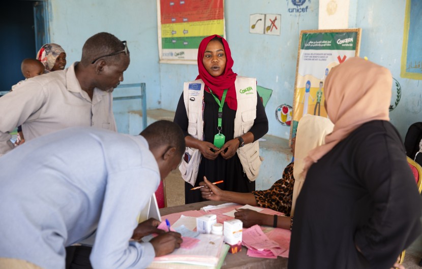 Concern staff in Sudan standing at table and speaking