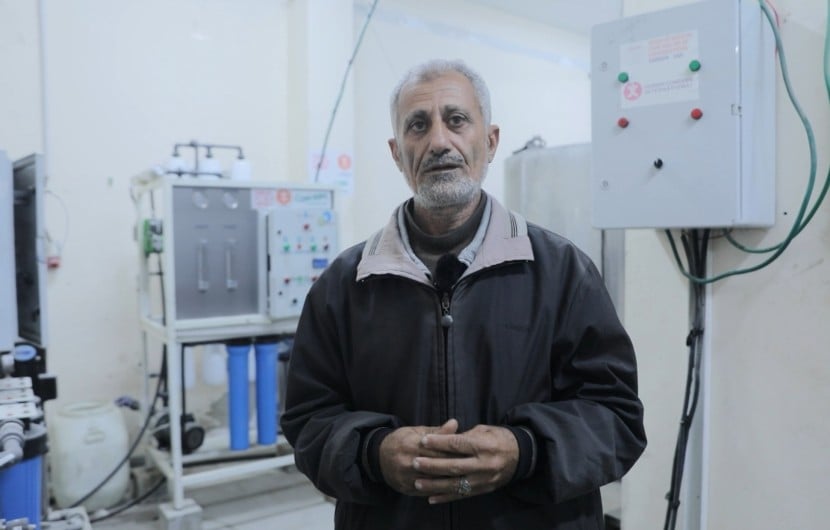 A man stands in front of a water filter in a hospital