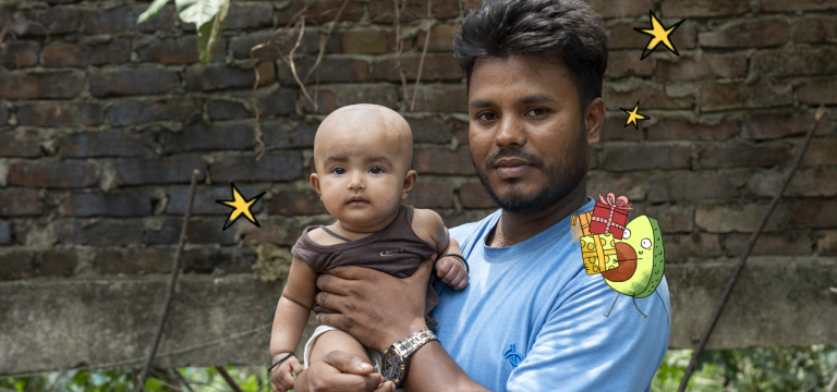 A father wearing a light blue shirt holds a young child while standing outdoors in front of a brick wall. Both look toward the camera. Playful illustrated elements, including stars and a cartoon avocado carrying wrapped gifts, are added around them, creating a cheerful Father’s Day-themed image.