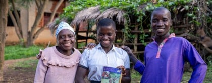 Ndagijimana and Julienne stand with their daughter Sandrine, one of their ten children