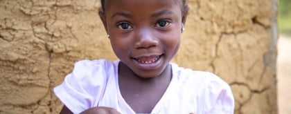 Tina (5) of Toe Town, holding a cup of water. Photo: Gavin Douglas/Concern Worldwide