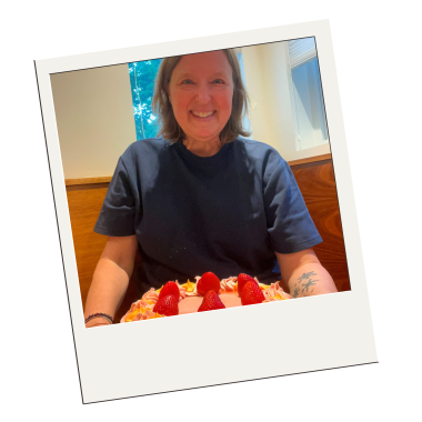 Carol celebrating her birthday with a strawberry cake