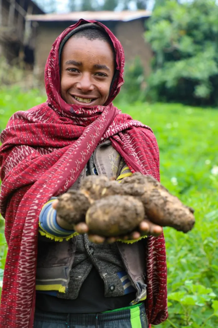 Mehamed's family only had barley to grow their farm, which limited their income as well as their diets. Now, thanks to Concern, they grow potatoes, as well as apples, and earn enough for Mehamed and his siblings to go to school. Photo: Jennifer Nolan/Concern Worldwide