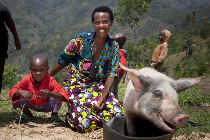 Violette Bukeyeneza (45) and her son LievainIrankunda 3 (M) with the pig she has bought from the profits of her business at her home in Bukinanyana, Cibitoke, Burundi. She is a beneficiary of the Graduation programme and her business has gone from strength to strength. Photo: Abbie Trayler-Smith / Concern Worldwide Violette Bukeyeneza (45) and her son LievainIrankunda 3 (M) with the pig she has bought from the profits of her business at her home in Bukinanyana, Cibitoke, Burundi. She is a beneficiary of the Graduation programme and her business has gone from strength to strength. Photo: Abbie Trayler-Smith / Concern Worldwide