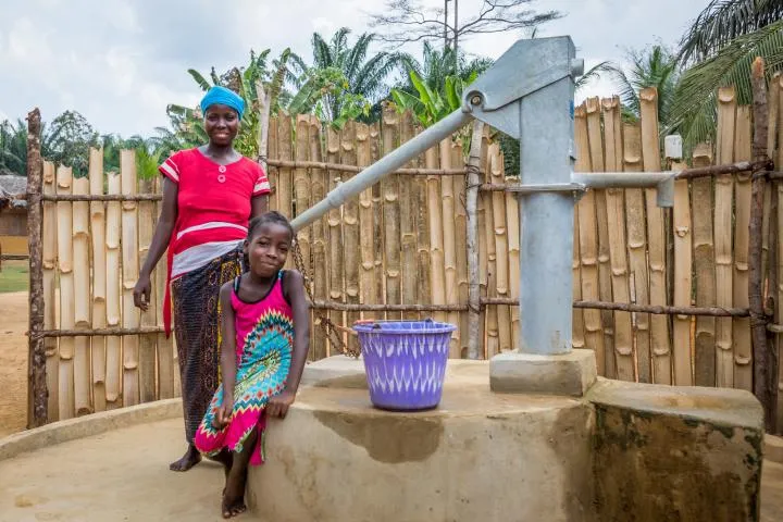 Irene with her daughter Lucy (8). As part of the WASH program, Concern have educated the community on good hygiene practices and installed this water pump. Photo: Gavin Douglas/Concern Worldwide Irene with her daughter Lucy (8). As part of the WASH program, Concern have educated the community on good hygiene practices and installed this water pump. Photo: Gavin Douglas/Concern Worldwide