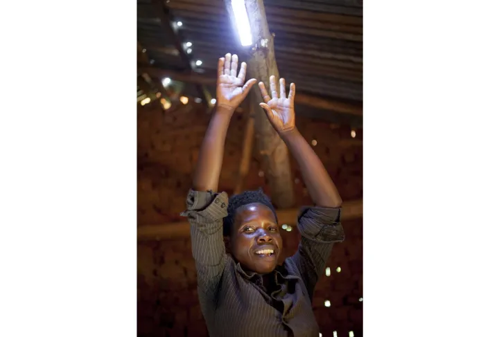 Alphonsine Niyonzima (21) with the solar lighting she has bought with the profits of her business, thanks to investment from the Graduation Programme. At her home in Mabayi, Cibitoke. Photo: Abbie Trayler-Smith / Concern Worldwide Alphonsine Niyonzima (21) with the solar lighting she has bought with the profits of her business, thanks to investment from the Graduation Programme. At her home in Mabayi, Cibitoke. Photo: Abbie Trayler-Smith / Concern Worldwide