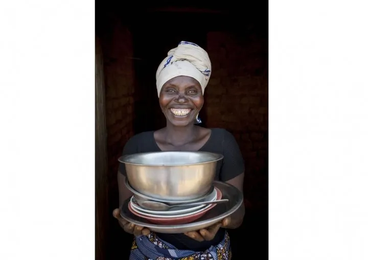 Meresiyana Cimpaya, 40, shows off her new plates, bowls, and pans in Burundi. Photo: Abbie Trayler-Smith / Concern Worldwide Meresiyana Cimpaya, 40, shows off her new plates, bowls, and pans in Burundi. Photo: Abbie Trayler-Smith / Concern Worldwide