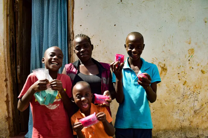 Lizzie and her children Mathews, Given and Trust, with the soap they need to protect themselves. Photo: Concern Worldwide