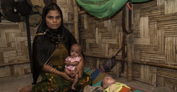 Mahfuja* with 7-month-old twins Rihana* (pink) and Sabiha* (mint green). A Concern Worldwide outreach Nutrition Team discovered that her twin girls were severely malnourished. They were treated at a nearby Concern Nutrition Outpatient Therapeutic Programme centre. Bangladesh. Photo: Abir Abdullah/ Concern Worldwide