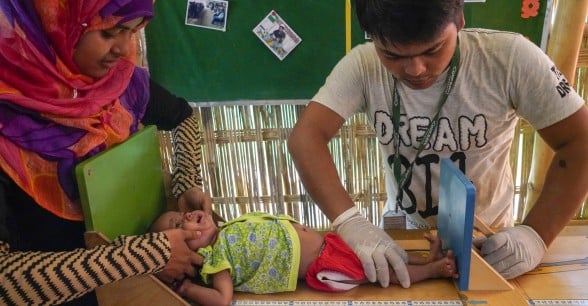 Concern staff in Cox's Bazar screen Azara* for malnutrition. Photo: Abir Abdullah / Concern Worldwide.