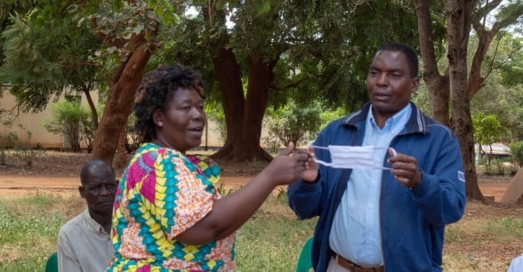 Chrisy Kumvula and Paul Chitsuro, demonstrating to participants on the proper use of masks. Malawi Photo: Henry Mhango
