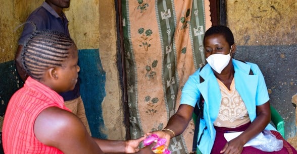 Mary Ambweni, Health Surveillance Assistant, at a heath centre in Lilongwe distributing soap to beneficiaries.