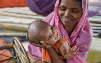 Noor* (21) holds one of her twin girls Nur* in their tent, Jamtoli, Ukhiya. Photo: Abir Abdullah/Concern Worldwide