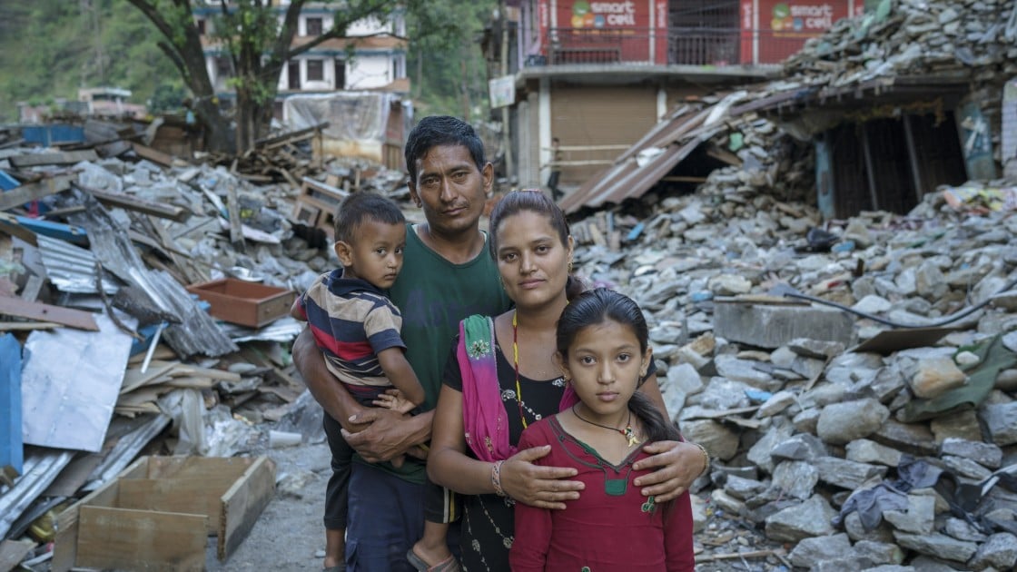 Niv and Shanti Shrestha and their children stand amongst the devastation caused by the earthquake in Dolakha district, Nepal. Photographer: Brian Sokol, 2015, Nepal