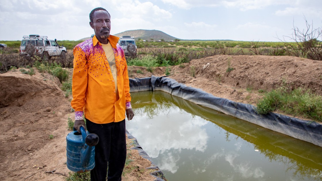 A lead farmer stands by his water catchment system in North Somaliland. As part of the climate change adaptation work, Concern provided him with a tarpaulin to which he has sank into a hole to store as much water as he can for his crops during the dry season.