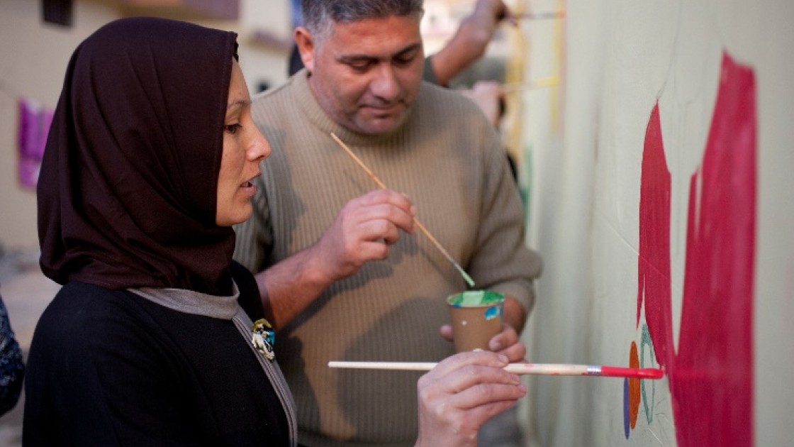 Tarek and Zeinah attend an art workshop with refugee families at a Concern supported Collective Centre in Northern Lebanon in December 2015. Zeinah and Tarek now live with their three children and two other families. Photo: Panos Pictures/Concern Worldwid