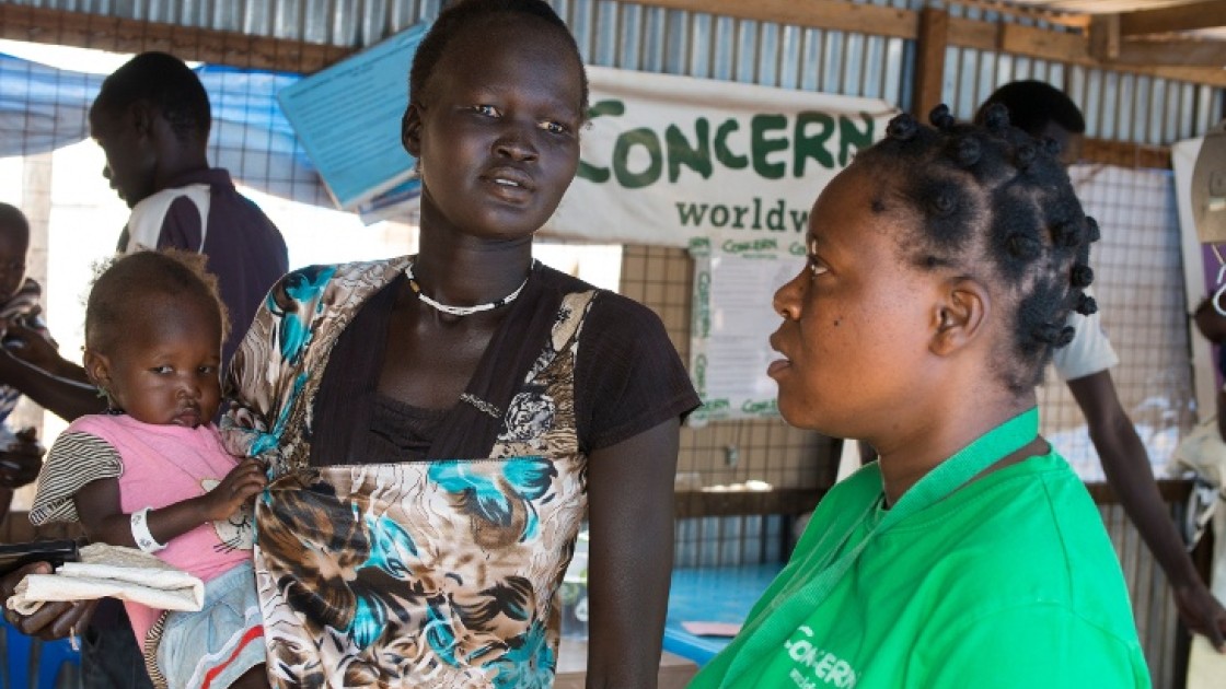 Nyakong Kwach and her 12 month old daughter, Nyadhabitat, talk with Concern nutritionist, Tracy Dube at the Concern nutrition centre in a refugee camp in Juba, South Sudan. They took shelter here after fighting broke out in July 2016.
