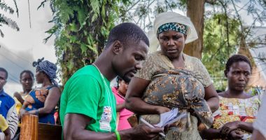 A Concern staff member checks the names of IDPs who have been registered to receive assistance in the Democratic Republic of Congo. Photo: Esdras Tsongo/Concern Worldwide