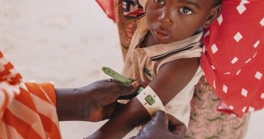 A child in Niger having their mid-upper arm circumference measured to screen for malnutrition