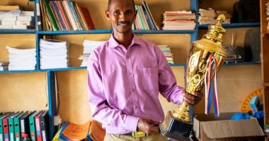 Mr. Boru Ali holds up a trophy won by his students from Bubisa Junior Secondary School at the 2023 Science Fair in Marsabit County. Photo: Eugene Ikua/Concern Worldwide