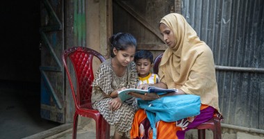 Renu Ara Begum (35) mother of three children and beneficiary of Concern Worldwide’s small business (tailoring). Renu Ara reading with her daughter Jhumka (10) at home in Ratna Palong, Ukhiya, Cox's bazar. Photo: Saikat Mojumder/Concern Worldwide
