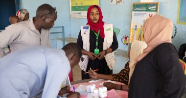 Concern staff in Sudan standing at table and speaking