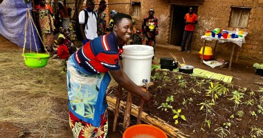 Maman Lumiere (lead mother) demonstrating hand washing in Karusi, Burundi. Photo:  Diane Moyer/Concern Worldwide.