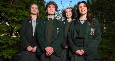 Four secondary school students standing together