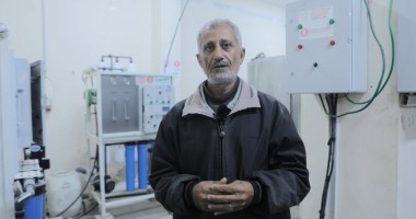 A man stands in front of a water filter in a hospital