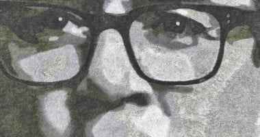 A close up of Andy Burnham's face drawn in greyscale on a field