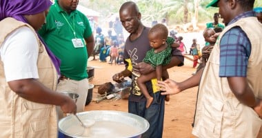 Imenje*, brings his son, Guy*, to receive the nutritious porridge in CAR. Photo: Mussa Uwitonze/Arete/Concern Worldwide.