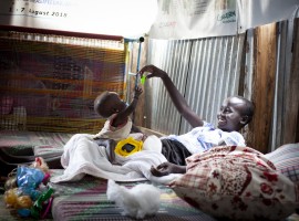 Dehlia* with her sister Koaloch* hang out in the mother and baby room in the Concern Nutrition Clinic in a POC in Juba, South Sudan. Photo: Abbie Trayler-Smith