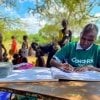 Concern Nurse Beatrice fills detail in the records book at an outreach centre in Kenya. Photo: Jennifer Nolan