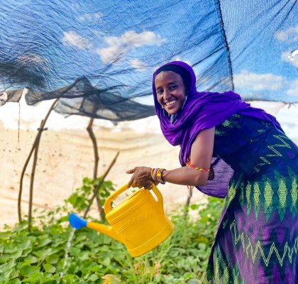 Sori, in her kitchen garden in Marsabit county, Kenya, watering her plants. Photo: Jennifer Nolan / Concern Worldwide / Kenya