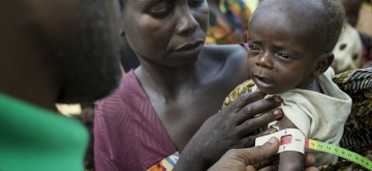 Mum Augustine Gbaguene has her three-month-old son Passi Kette’s mid-upper arm measurement taken. The indications are that he is severely malnourished. Photo: Chris de Bode / CAR