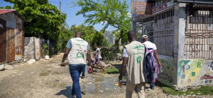 Concern staff arrive for a workshop on making liquid and solid soap in Cite Soleil slum, a district of Port-au-Prince. Photo: Dieu Nalio Chery