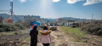 Mother of 4 Nahida* walking through her camp with Concern Officer Samah. Nahida's landlord is building extensively on the land making it very inhospitable for her and her family. Photo: Gavin Douglas