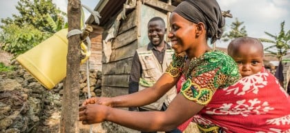 Apoline Niyosenge is taught how to wash her hands properly by Concern community worker Abel Bamwisho, DRC. Photo: Pamela Tulizo