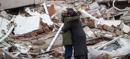 Women hug near a collapsed building in Turkey after one loses her brother in the devastating earthquake in February 2023. Photo: Burak Kara/Getty Images